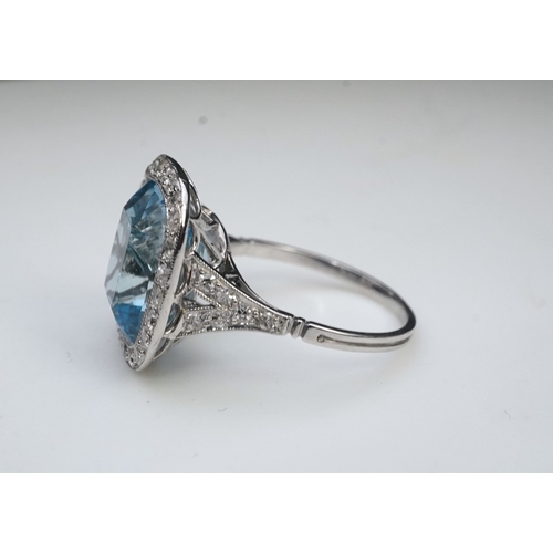 436 - An attractive aquamarine and diamond ring, of cluster design, set with a cushion-shaped aquamarine, ... 