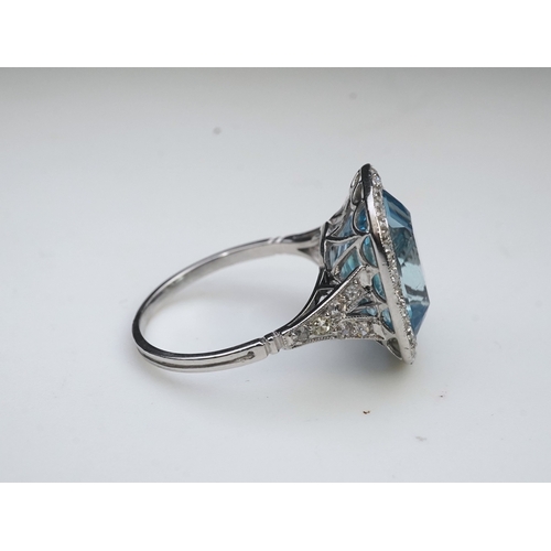 436 - An attractive aquamarine and diamond ring, of cluster design, set with a cushion-shaped aquamarine, ... 