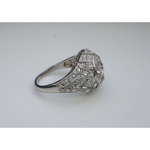 437 - A diamond dress ring, in the Belle Epoque style, of bombé design in millegrain-bordered openwork, se... 