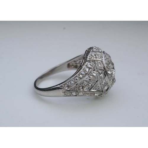 437 - A diamond dress ring, in the Belle Epoque style, of bombé design in millegrain-bordered openwork, se... 