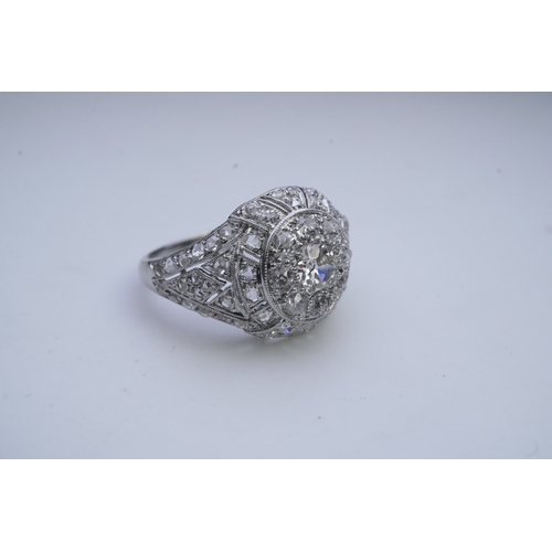 437 - A diamond dress ring, in the Belle Epoque style, of bombé design in millegrain-bordered openwork, se... 