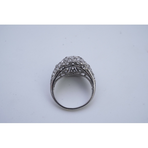 437 - A diamond dress ring, in the Belle Epoque style, of bombé design in millegrain-bordered openwork, se... 