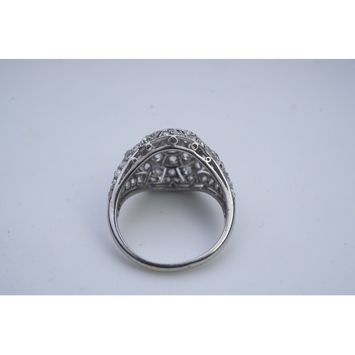 437 - A diamond dress ring, in the Belle Epoque style, of bombé design in millegrain-bordered openwork, se... 