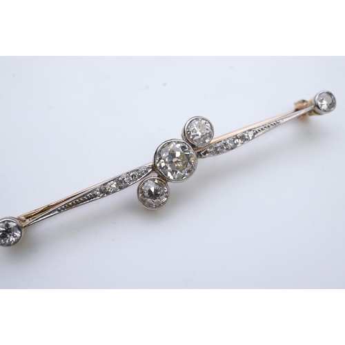 440 - An Edwardian diamond brooch, early 20th century, centring on a diagonal line of three circular-cut d... 