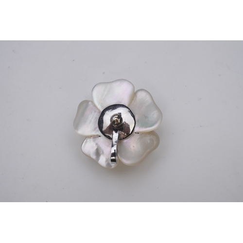 441 - A mother of pearl and diamond pendant designed as a flower in carved mother of pearl, the centre pav... 