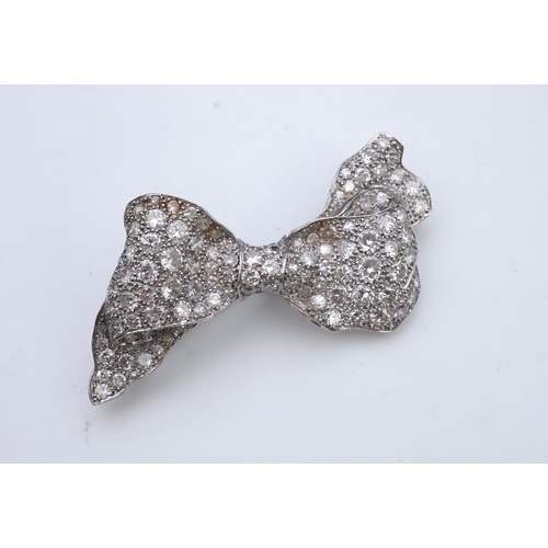 442 - A diamond brooch, mid 20th century, designed as a ribbon bow, pavé-set with circular- and single-cut... 