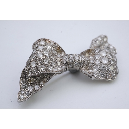 442 - A diamond brooch, mid 20th century, designed as a ribbon bow, pavé-set with circular- and single-cut... 