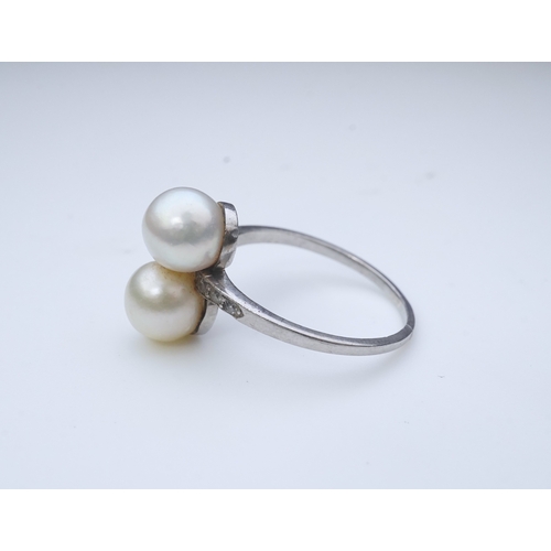 444 - A pearl and diamond toi-et-moi ring, circa 1920 set with a pair of pearls, each measuring approximat... 