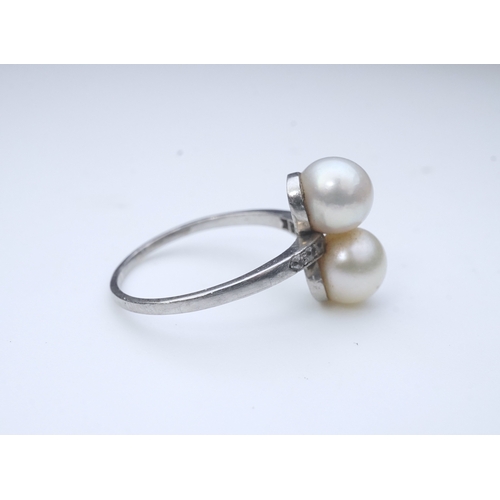 444 - A pearl and diamond toi-et-moi ring, circa 1920 set with a pair of pearls, each measuring approximat... 