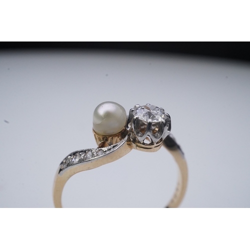 447 - A pearl and diamond toi-et-moi ring, early 20th century, of crossover design, set with a circular-cu... 