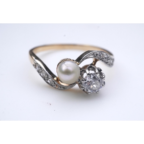 447 - A pearl and diamond toi-et-moi ring, early 20th century, of crossover design, set with a circular-cu... 