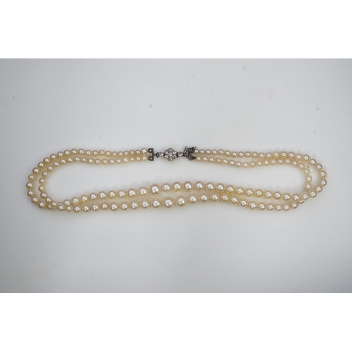 448 - A cultured pearl and diamond necklace, early 20th century and later, the clasp designed as a millegr... 