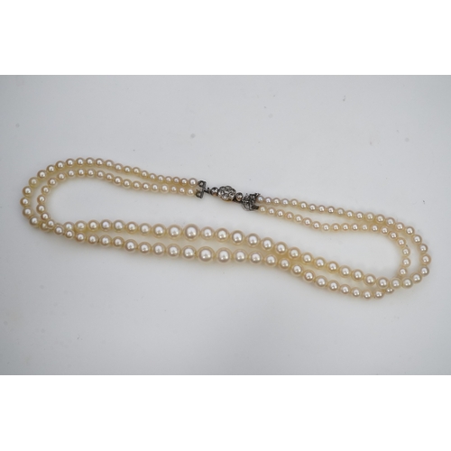 448 - A cultured pearl and diamond necklace, early 20th century and later, the clasp designed as a millegr... 