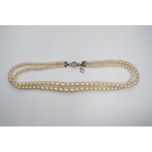 448 - A cultured pearl and diamond necklace, early 20th century and later, the clasp designed as a millegr... 