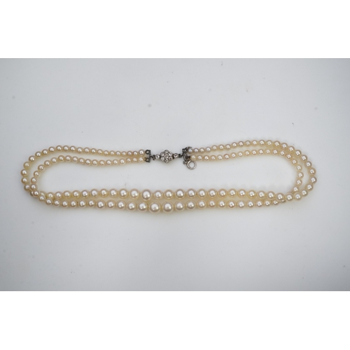 448 - A cultured pearl and diamond necklace, early 20th century and later, the clasp designed as a millegr... 