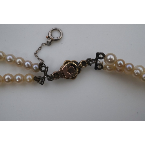 448 - A cultured pearl and diamond necklace, early 20th century and later, the clasp designed as a millegr... 