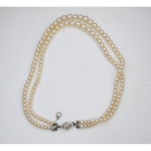 448 - A cultured pearl and diamond necklace, early 20th century and later, the clasp designed as a millegr... 