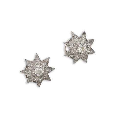 449 - A pair of Art Deco diamond ear clips, 1930s, each designed as an eight-rayed star, pavé-set with cus... 