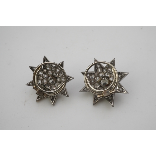 449 - A pair of Art Deco diamond ear clips, 1930s, each designed as an eight-rayed star, pavé-set with cus... 