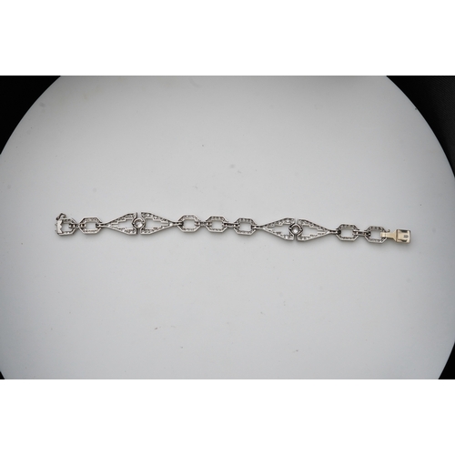 450 - An Art Deco diamond bracelet, France, circa 1930, composed of geometric linking, set with circular-c... 