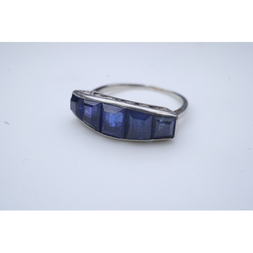 452 - An Art Deco sapphire ring, 1930s, designed as a sequence of five channel-set calibré-cut sapphires, ... 