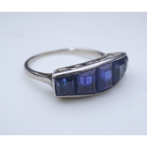 452 - An Art Deco sapphire ring, 1930s, designed as a sequence of five channel-set calibré-cut sapphires, ... 