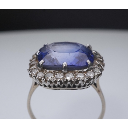 454 - A synthetic sapphire and diamond cluster ring, early 20th century, of cluster design, set with a cus... 