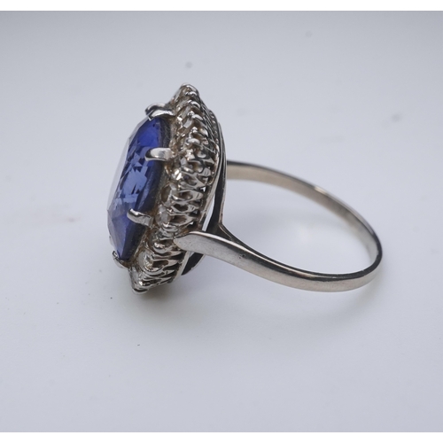 454 - A synthetic sapphire and diamond cluster ring, early 20th century, of cluster design, set with a cus... 