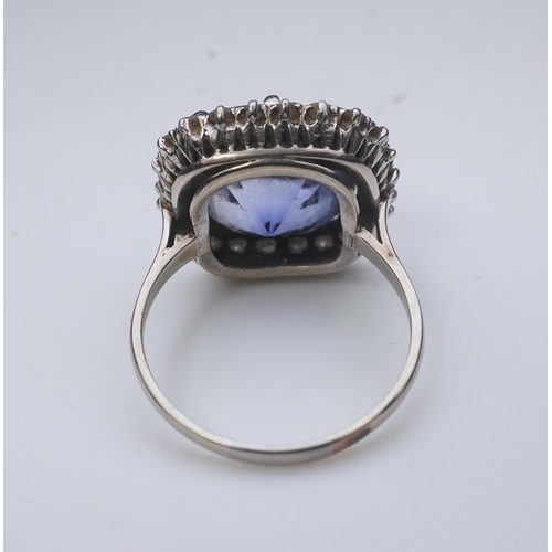 454 - A synthetic sapphire and diamond cluster ring, early 20th century, of cluster design, set with a cus... 