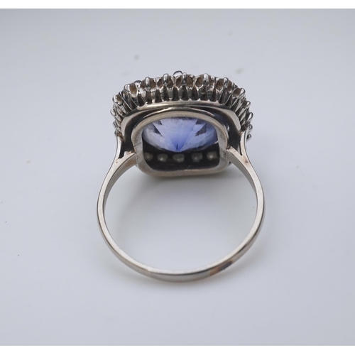 454 - A synthetic sapphire and diamond cluster ring, early 20th century, of cluster design, set with a cus... 