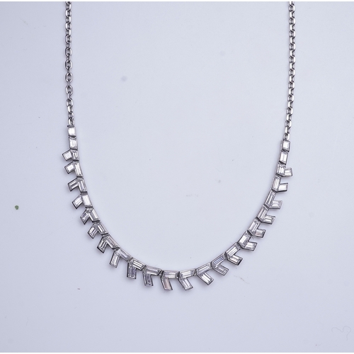 455 - A diamond necklace, the front composed of geometric links set with rhomboid baguette diamonds, to a ... 