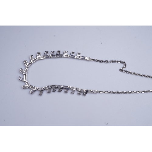 455 - A diamond necklace, the front composed of geometric links set with rhomboid baguette diamonds, to a ... 