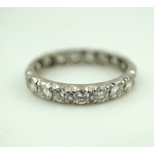 458 - A diamond eternity ring, set with a continuous band of brilliant-cut diamonds totalling approximatel... 