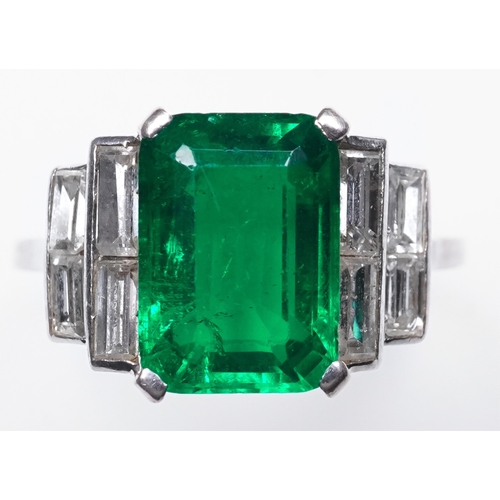 465 - A fine Art Deco emerald and diamond ring, circa 1930 claw-set with a step-cut emerald weighing appro... 