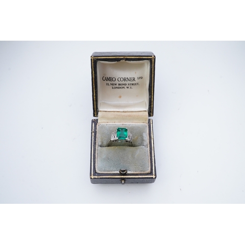 465 - A fine Art Deco emerald and diamond ring, circa 1930 claw-set with a step-cut emerald weighing appro... 