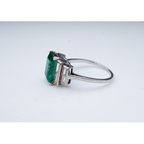 465 - A fine Art Deco emerald and diamond ring, circa 1930 claw-set with a step-cut emerald weighing appro... 