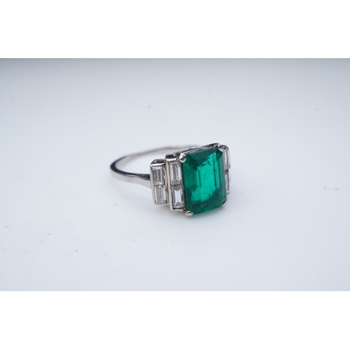 465 - A fine Art Deco emerald and diamond ring, circa 1930 claw-set with a step-cut emerald weighing appro... 