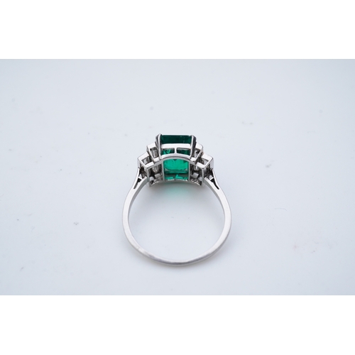 465 - A fine Art Deco emerald and diamond ring, circa 1930 claw-set with a step-cut emerald weighing appro... 