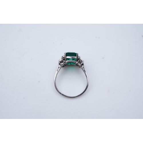 465 - A fine Art Deco emerald and diamond ring, circa 1930 claw-set with a step-cut emerald weighing appro... 