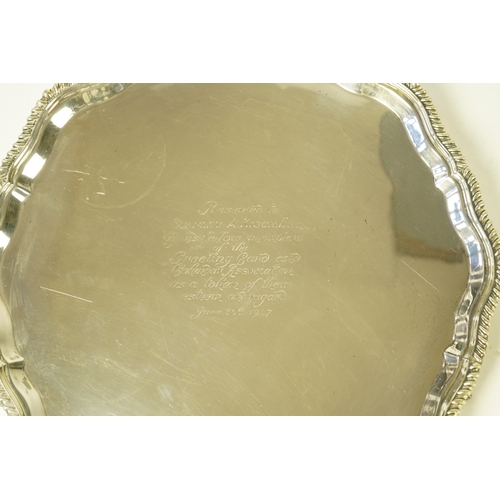 59 - An Edwardian silver salver, by Mappin & Webb, of shaped circular form, with gadrooned border and lat... 