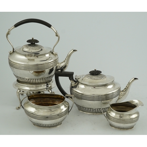 62 - A matched Edwardian Scottish four piece demi fluted oval silver tea service by Wilson & Sharp, compr... 