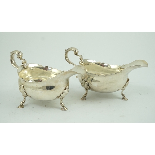 7 - A pair of late George II silver sauceboats by Robert Albin Cox, with cut borders and scroll handles,... 