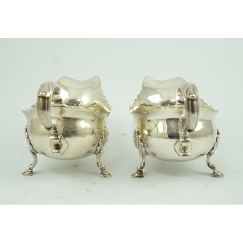 7 - A pair of late George II silver sauceboats by Robert Albin Cox, with cut borders and scroll handles,... 