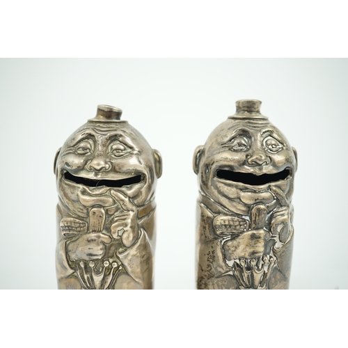 72 - A matched pair of George V novelty silver money boxes, each cylindrical box embossed as a banker wit... 