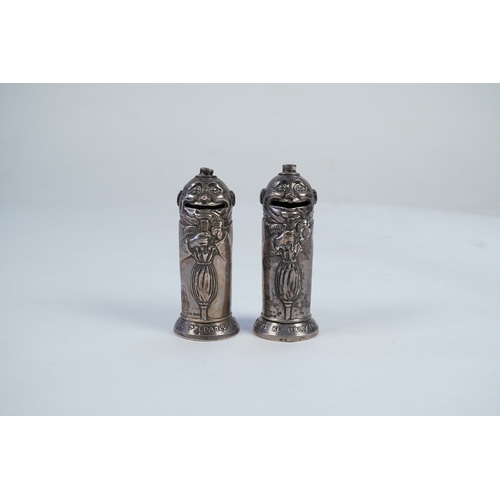 72 - A matched pair of George V novelty silver money boxes, each cylindrical box embossed as a banker wit... 