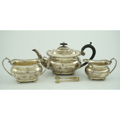 78 - A George VI  silver three piece tea set, by George Howson, of oval form, with gadrooned and shell bo... 