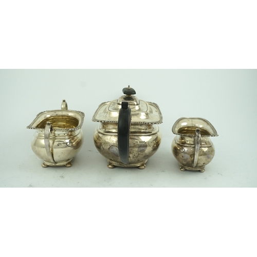 78 - A George VI  silver three piece tea set, by George Howson, of oval form, with gadrooned and shell bo... 