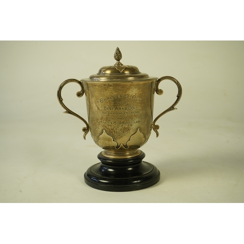 79 - A George V silver two handled presentation cup and cover by Johnson, Walker & Tolhurst, with later e... 