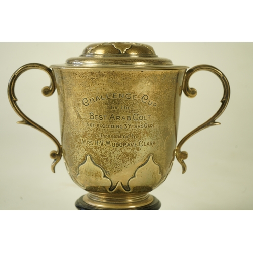 79 - A George V silver two handled presentation cup and cover by Johnson, Walker & Tolhurst, with later e... 