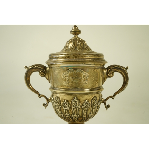 81 - A George V silver two handled presentation cup and cover, by Charles & Richard Comyns, with engraved... 